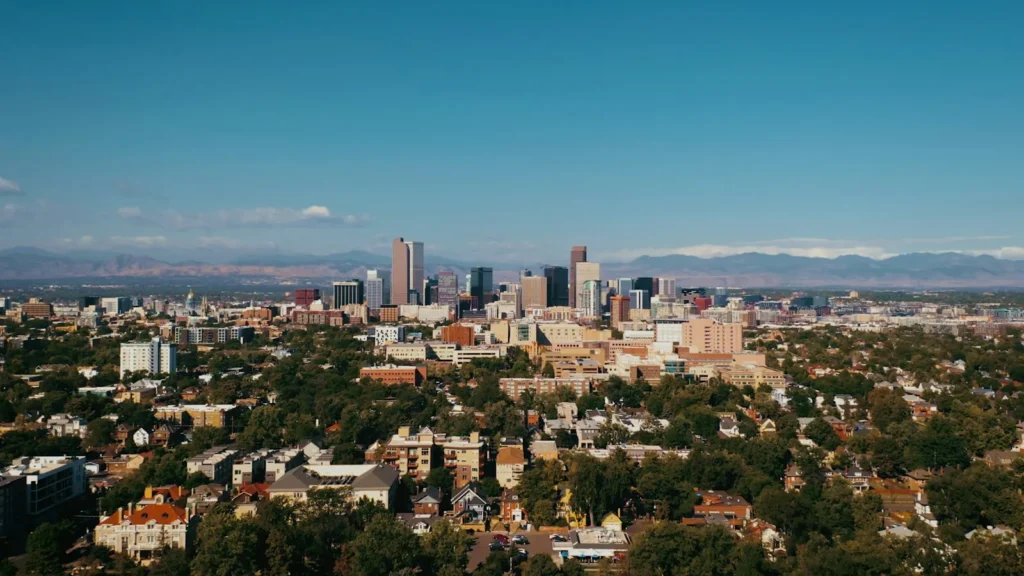 A downtown street with mountains behind