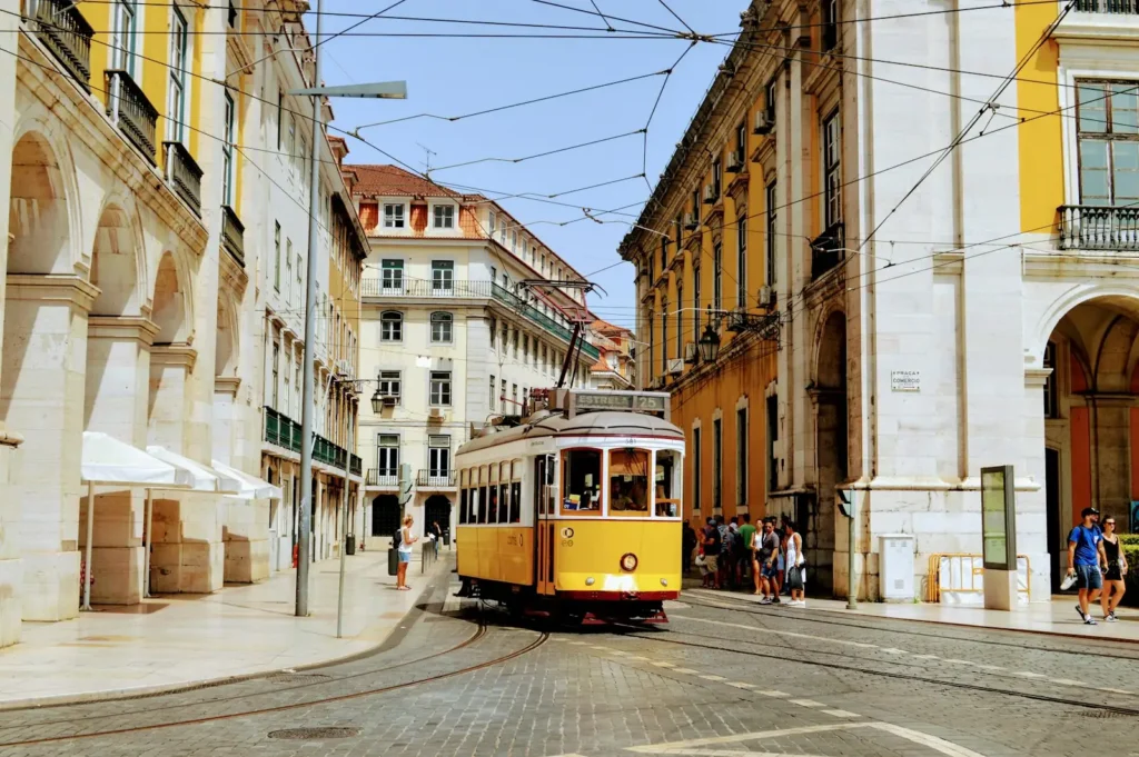 A yellow tram in a street of old buildings